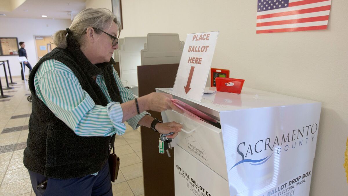 Heather Tilson deposits her ballot at the Sacramento County Registrar of Voters office on Oct. 24.