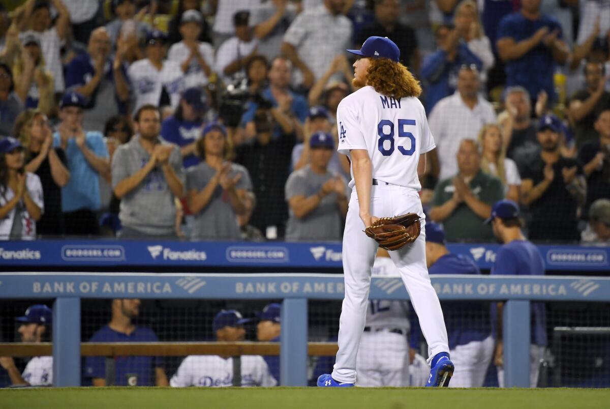 Dodgers starter Dustin May walks off the field to a standing ovation after being relieved in the sixth inning of a 5-2 loss to the San Diego Padres on Friday.