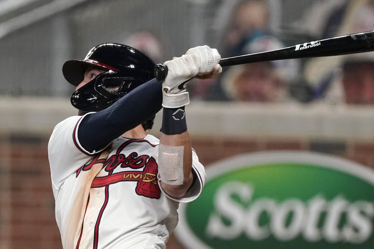 Atlanta Braves' Dansby Swanson follows through on a game-ending, two-run home run in the ninth inning of the team's baseball game against the Washington Nationals on Monday, Aug. 17, 2020, in Atlanta. The Braves won 7-6. (AP Photo/John Bazemore)