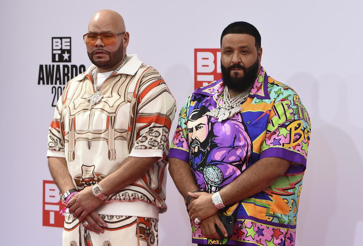 Fat Joe, left, and DJ Khaled stand with their hands crossed in front of them at an event