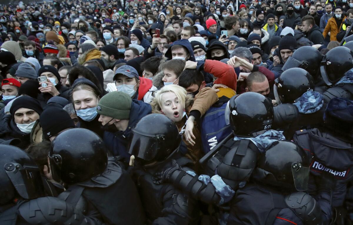 People clash with police during a protest against the jailing of Alexei Navalny in St. Petersburg, Russia.