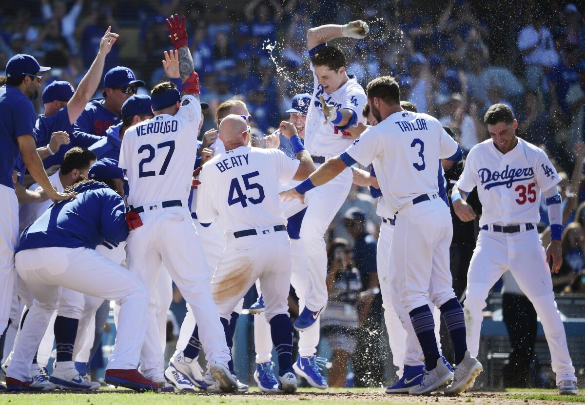 Pinch hitter Will Smith, third from right, celebrates with his teammates after hitting a walk-off home run during the ninth inning of the Dodgers' 6-3 victory over the Colorado Rockies on Sunday.