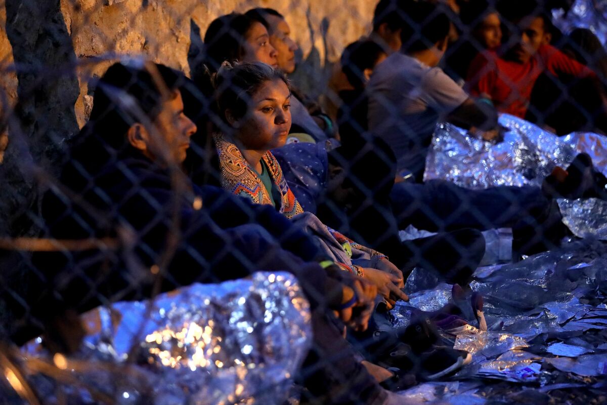 Hundreds of migrants seeking asylum are held in a temporary "transitional" shelter.