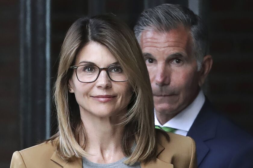 Lori Loughlin, front, and husband, clothing designer Mossimo Giannulli