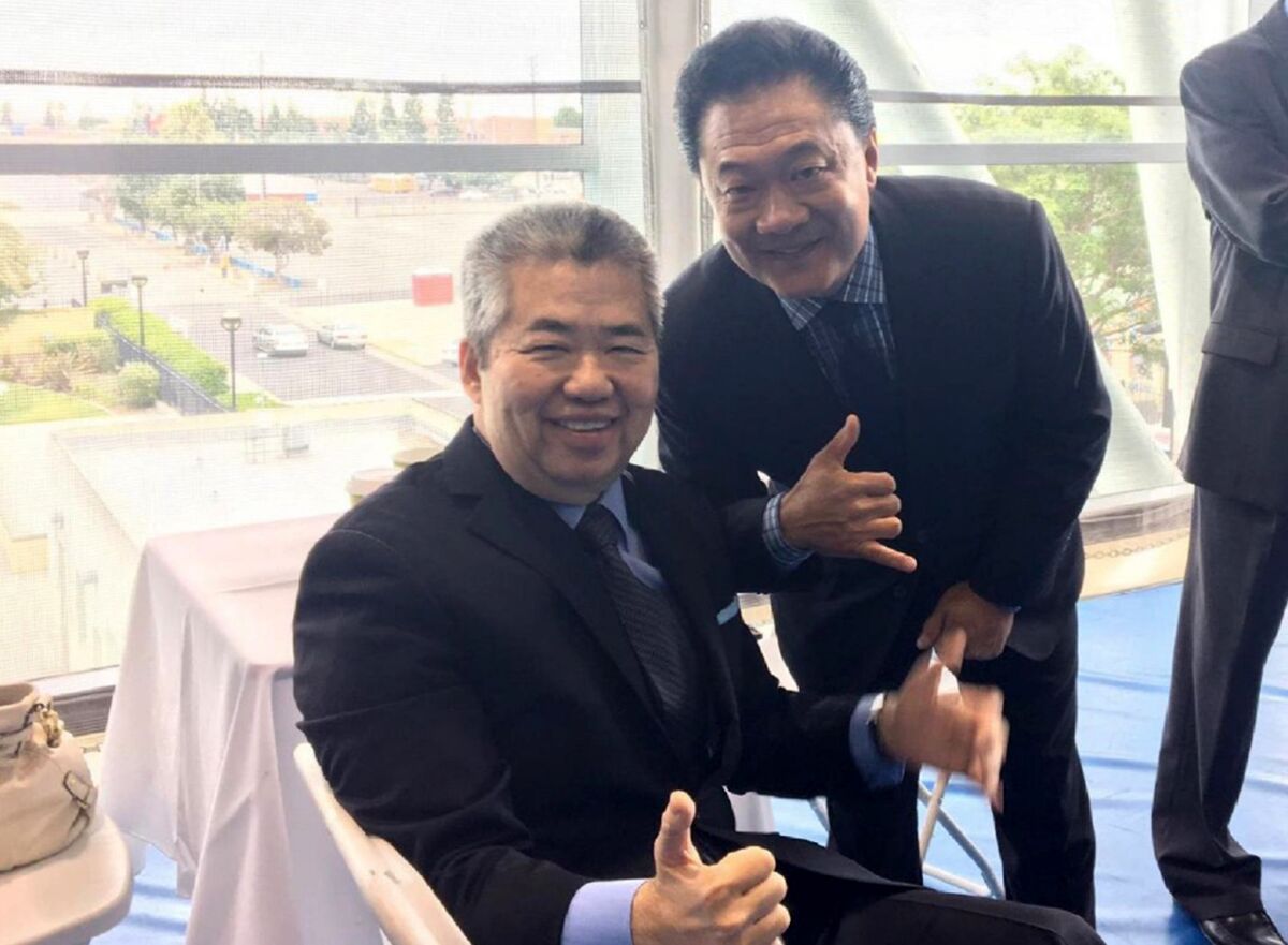 Raymond Chan and Joel Jacinto pose with a thumbs-up.