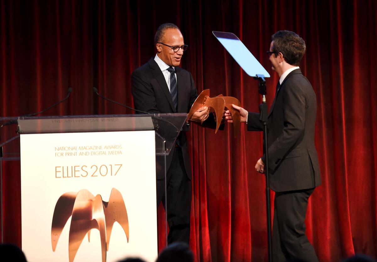Douglas McGray accepts an award from Lester Holt.