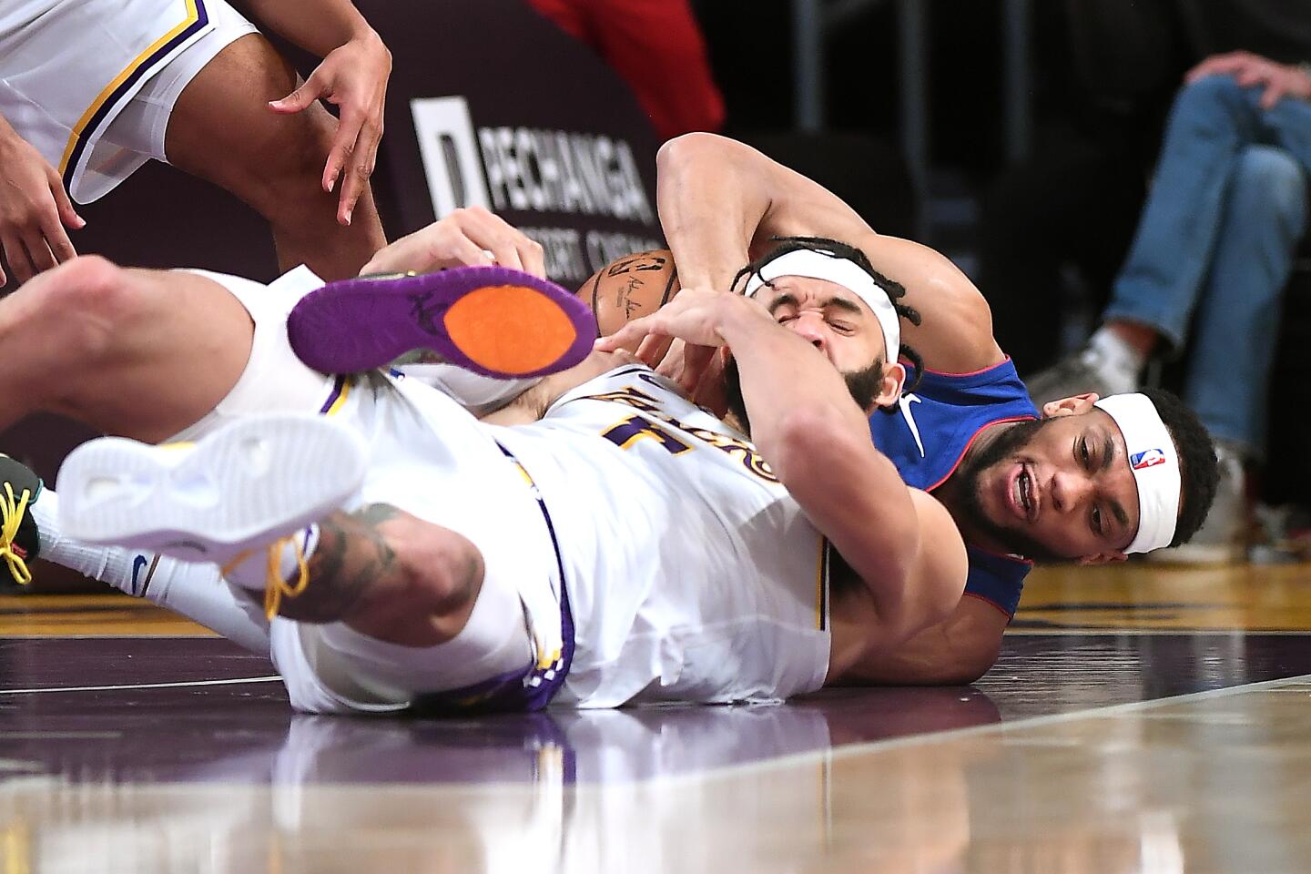 Lakers center JaVale McGee and Detroit Pistons guard Bruce Brown battle for a loose ball during the second quarter.
