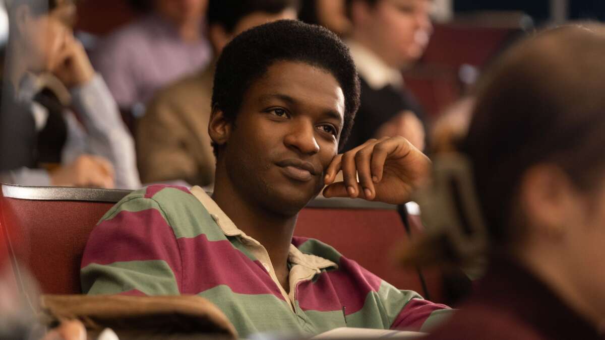 A Black student sits in a college class.