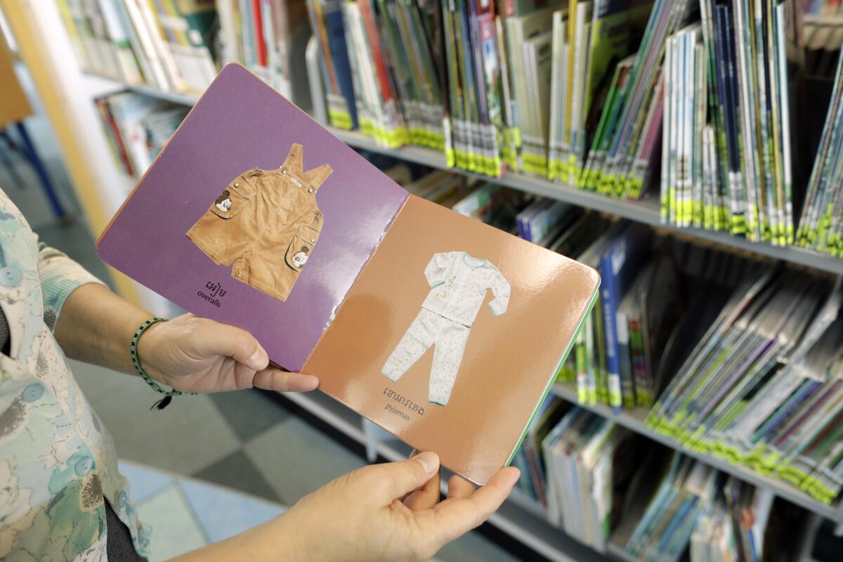 A person holds a children's book