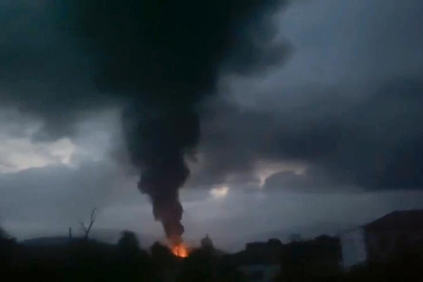 This grab taken from video distributed by Siranush Sargsyan's Twitter account on Monday, Sept. 25, 2023, shows smoke rising after a fuel depot explosion near Stepanakert, Nagorno-Karabakh. Several dozen people were injured on Monday night at a gas station just outside of the breakaway region's capital, Stepanakert, where a fuel tank exploded. Dozens of people were lining up at the gas station at the time to fuel their cars in order to move to Armenia. (Siranush Sargsyan's Twitter account via AP)