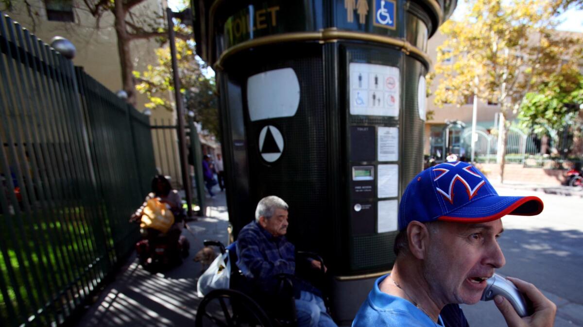 Men outside the public toilet at 5th and San Julian streets in downtown Los Angeles in 2013.
