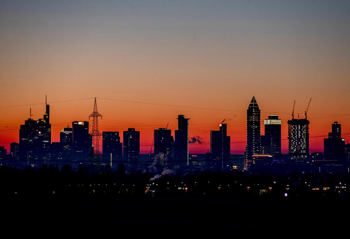 FILE - In this Feb.14, 2021 file photo the sun is about to rise behind the buildings of the banking district in Frankfurt, Germany. The European statistics agency Eurostat released monthly inflation figures Tuesday.(AP Photo/Michael Probst, file)