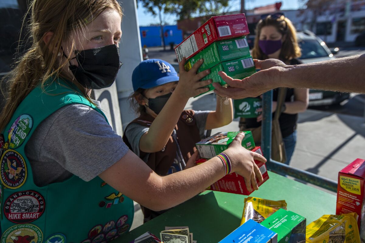 Business is brisk as Madar Mee, 10, left, and Emma Diaz, 7, sell Girl Scout cookies in their Mar Vista neighborhood.