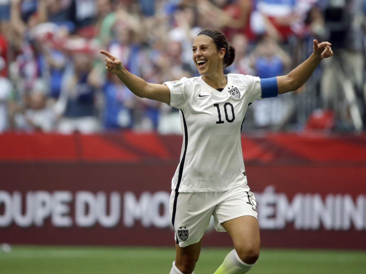 Carli Lloyd celebrates after scoring her third goal against Japan during the first half of the FIFA Women's World Cup championship in Vancouver, Canada, on July 5.