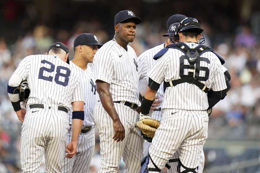 New York Yankees' Luis Severino huddles with teammates during the first inning of the team's baseball game against the Cincinnati Reds on Wednesday, July 13, 2022, in New York. (AP Photo/Frank Franklin II)