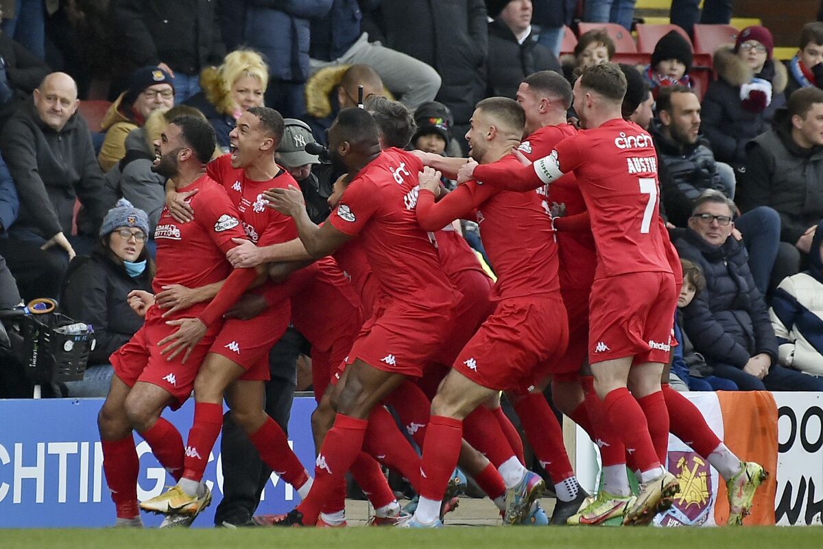 Kidderminster's Alex Penny, left, celebrates with teammates after scoring the opening goal during the English FA Cup fourth round soccer match between Kidderminster Harriers and West Ham United at Aggborough Stadium, Kidderminster, England, Saturday, Feb. 5, 2022. (AP Photo/Rui Vieira)