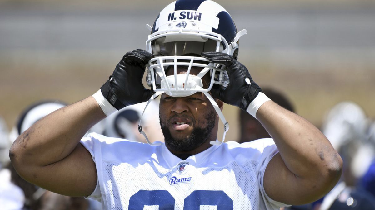 Rams' Ndamukong Suh puts on his helmet for practice at the team's training camp in Thousand Oaks on Tuesday.