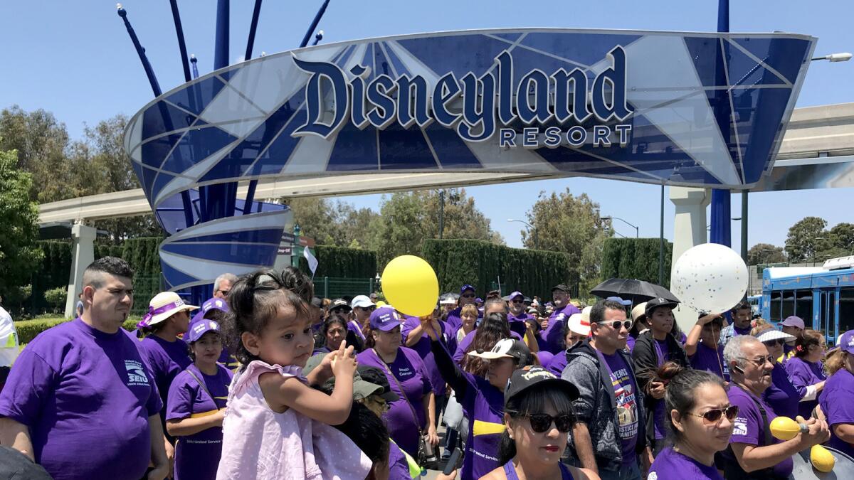 Disneyland workers from several unions protest at the entrance to Disneyland in Anaheim on July 3, 2018.