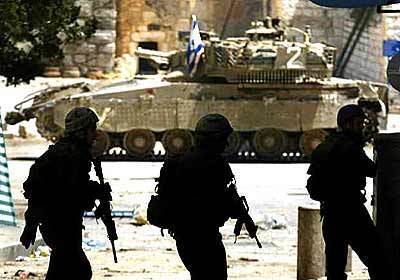 Israeli soldiers move around the Church of the Nativity.