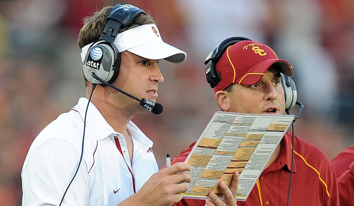 In 2010, Lane Kiffin, left, was head coach at USC; Clay Helton was his quarterbacks coach.