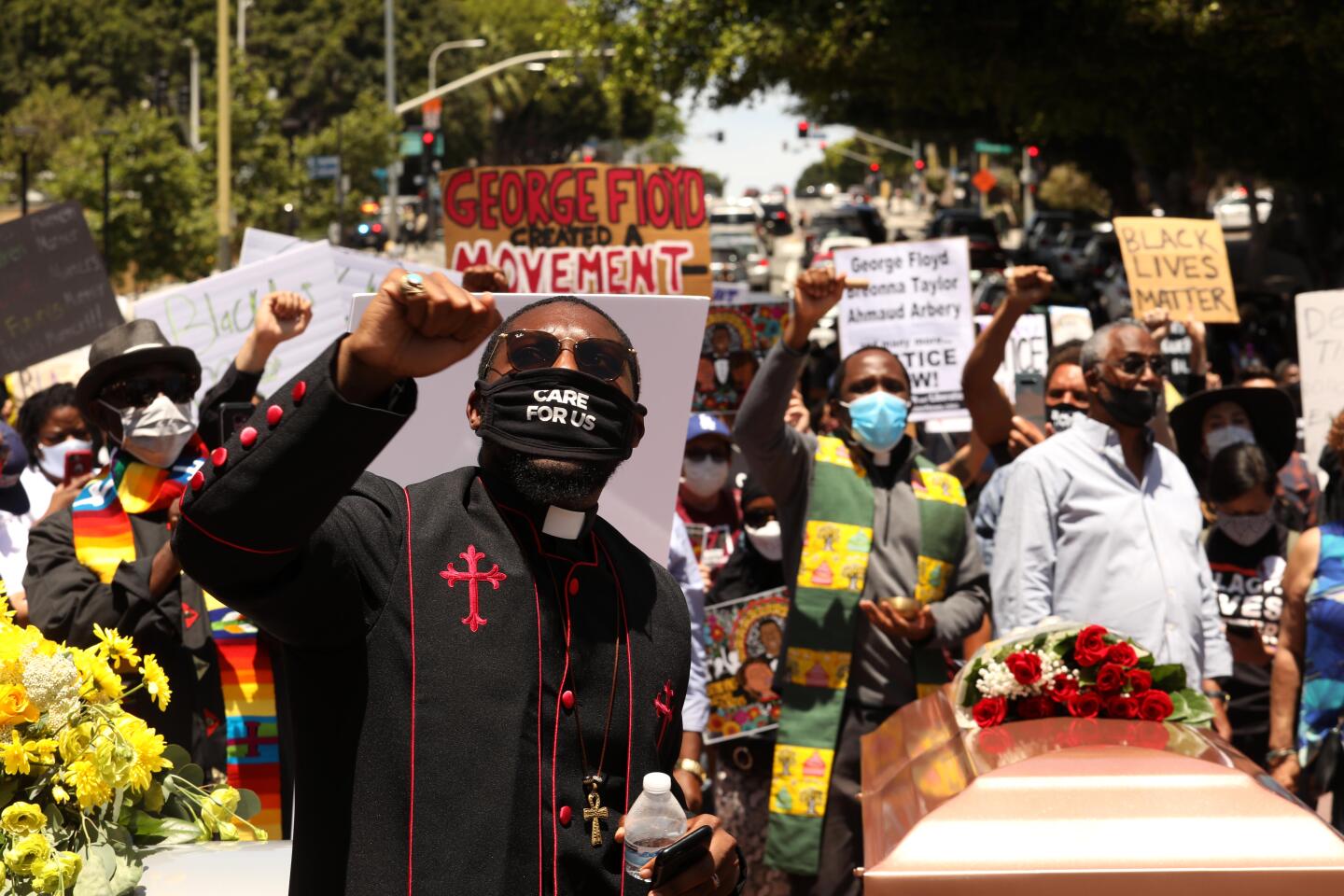 Pastor Eddie Anderson, foreground, joins hundreds at a funeral procession memorial service and to honor George Floyd in Downtown Los Angeles.