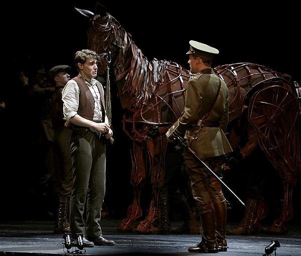A very upset Andrew Veenstra (Albert Narracott) is told by Jason Loughlin (Lieutenant James Nicholls) that he must say goodbye to the horse in the Tony-winning play "War Horse" at the Ahmanson Theatre.