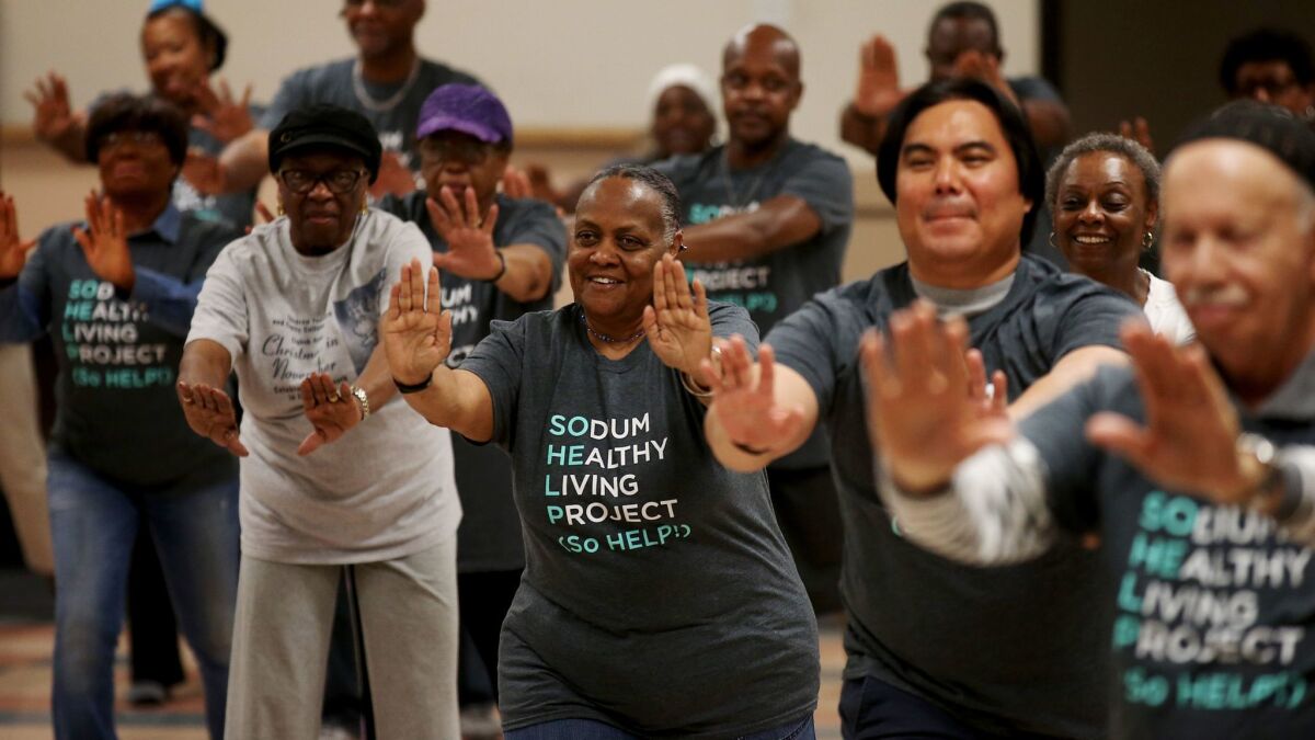 Participants in the Sodium Healthy Living Project perform tai chi at Holman Methodist Church. (Luis Sinco / Los Angeles Times)