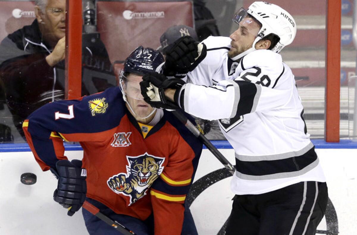 Kings center Jarret Stoll collides with Panthers defenseman Dmitry Kulikov in the second period Sunday.