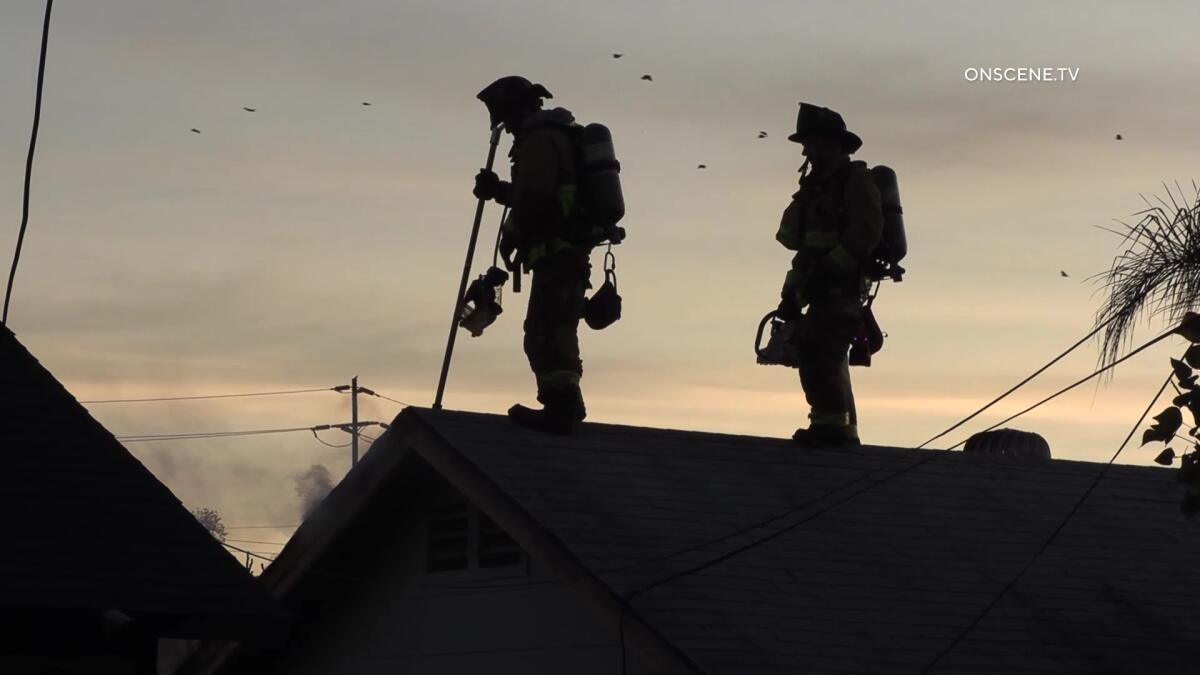 Firefighters on National City housetop Nov. 4