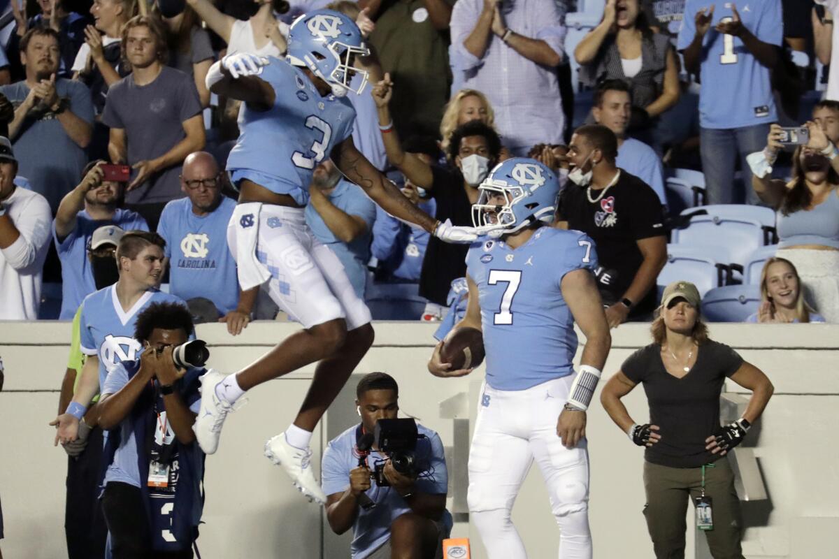 North Carolina quarterback Sam Howell (7) celebrates his touchdown run with wide receiver Antoine Green (3) during the first half of an NCAA college football game in Chapel Hill, N.C., Saturday, Sept. 11, 2021. (AP Photo/Chris Seward)