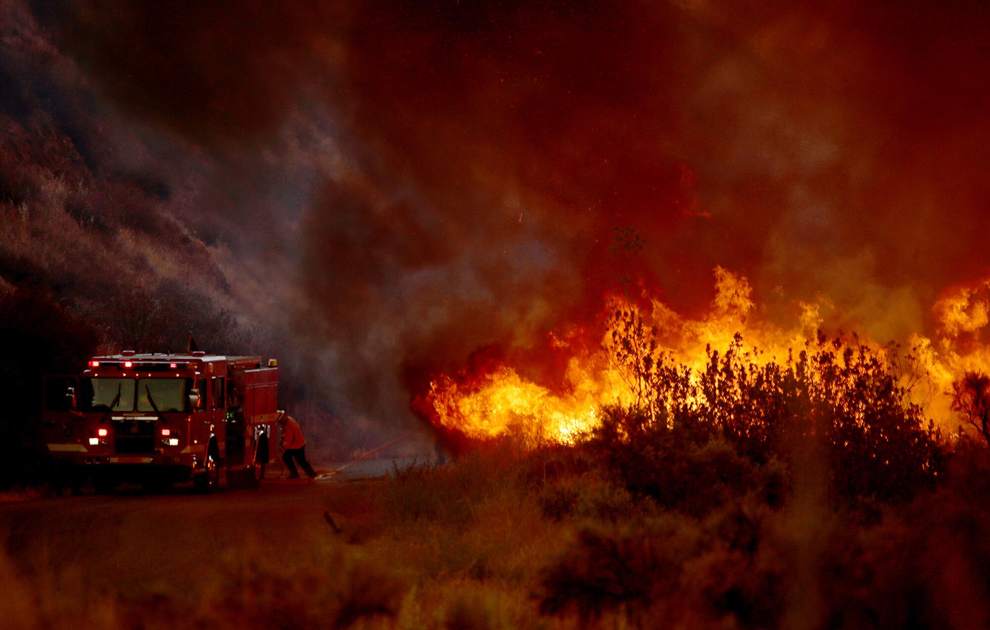 The Fairview fire burns along Batista Road near Hemet on Tuesday.