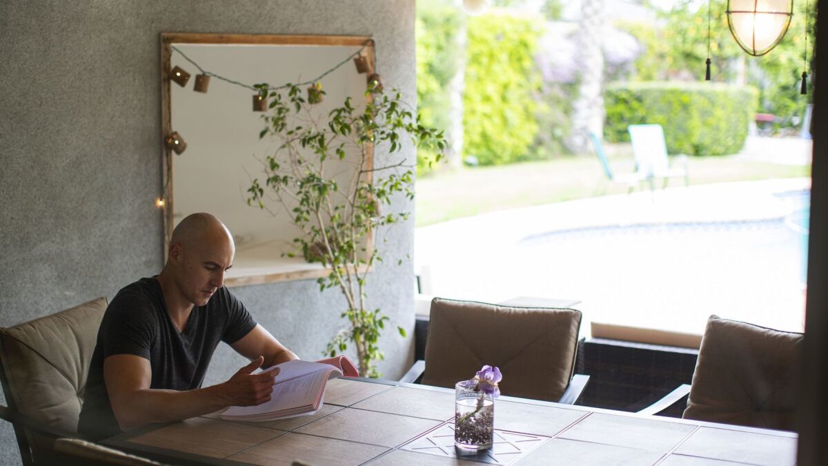 Actor Douglas Tait studies a script in his favorite room, the outdoor space on his backyard patio.