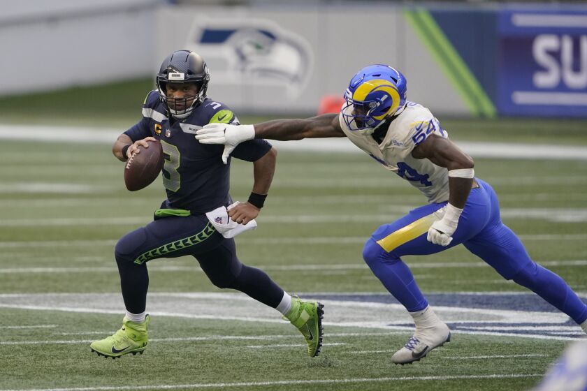 Rams edge rusher Leonard Floyd pursues Seattle Seahawks quarterback Russell Wilson on Jan. 9, 2021.
