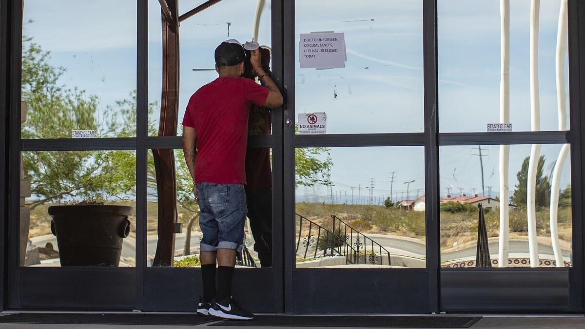 An Adelanto resident finds the doors locked at Adelanto City Hall after federal agents executed a search warrant there.