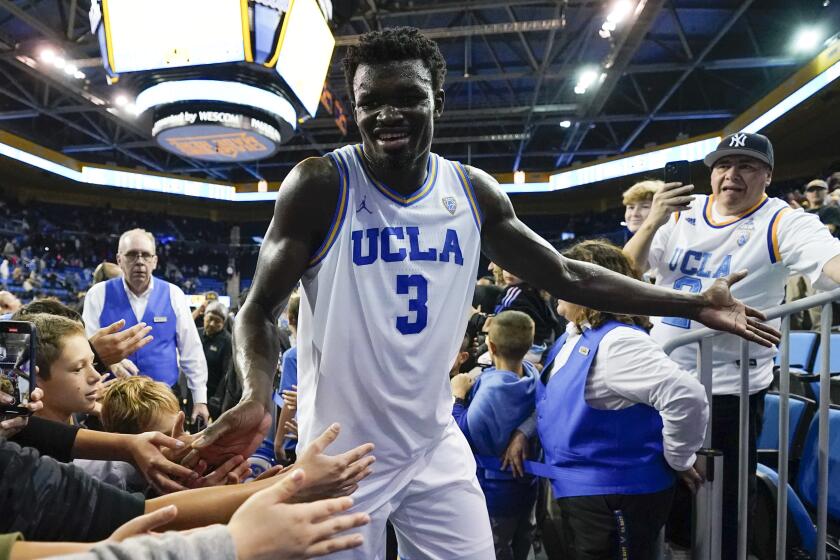 UCLA forward Adem Bona (3) greets fans as he leaves the court after a 68-54 win over Colorado.