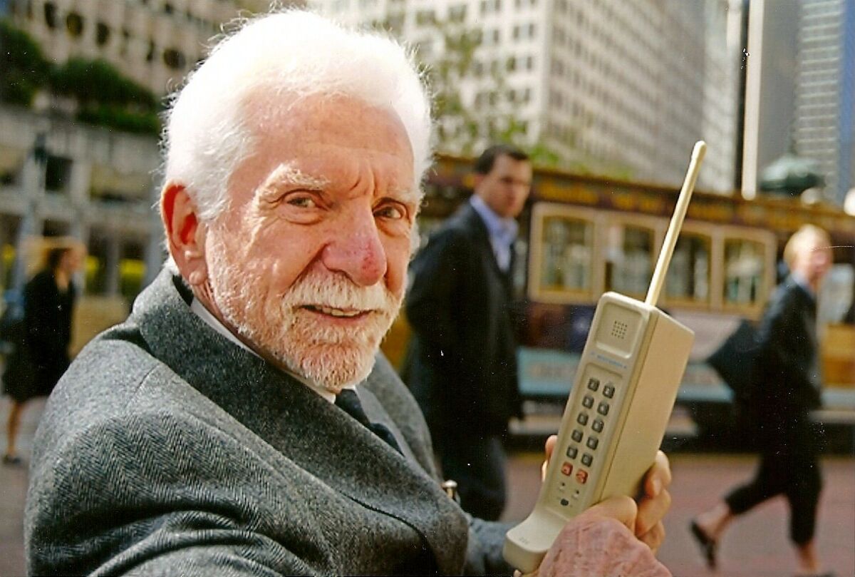 Inventor Martin "Marty" Cooper holds a replica of the first cellphone he designed at Motorola and debuted on April 3, 1973.