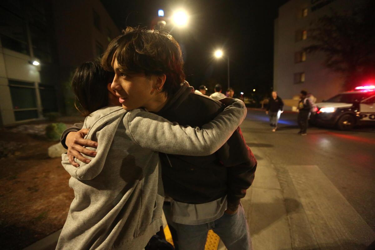 Two young people embrace.