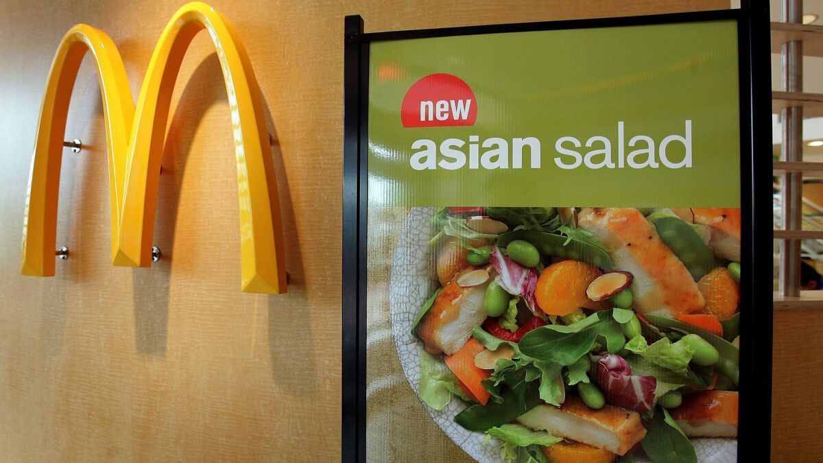 McDonald's halted sales Friday of salad items in 3,000 franchises in the Midwest, after an outbreak of a parasite-borne illness was linked to its greens in Illinois and Iowa.