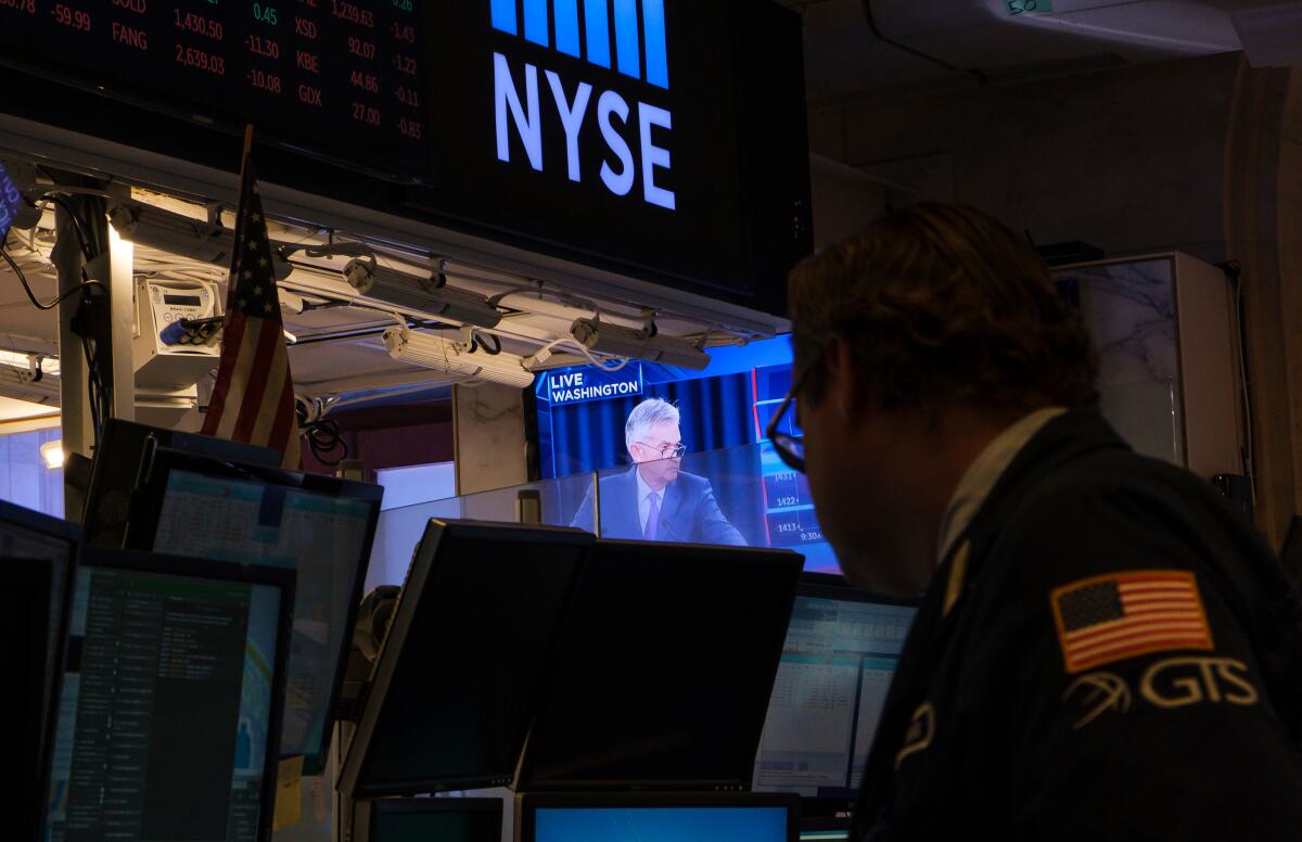 Mandatory Credit: Photo by JUSTIN LANE/EPA-EFE/REX (10351500f) A trader works near a television screen showing a news conference with United States Federal Reserve chairman Jerome Powell where he was discussed the Fed's decision to lower interest rates by a 1/4 point on the floor of the New York Stock Exchange in New York, New York, USA, 31 July 2019. The United States Federal Reserve lowered the key interest rate quarter a point for the first time since the 2008 financial crisis. New York Stock Exchange Fed Cuts Interest Rate, USA - 31 Jul 2019 ** Usable by LA, CT and MoD ONLY **