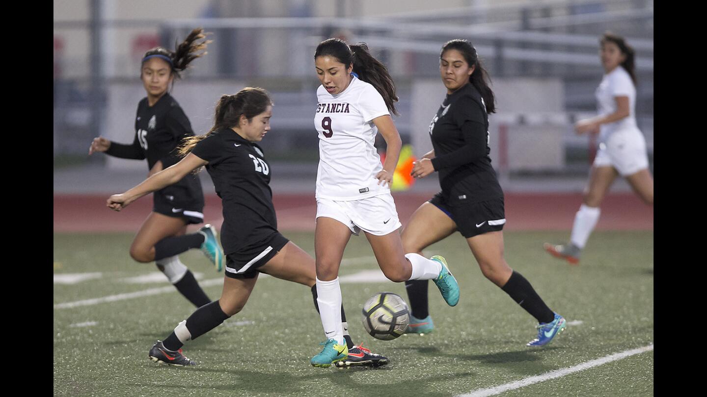 Estancia's Desiree Mendoza dribbles the ball through the Costa Mesa defense during the first half of the Battle of the Bell girls soccer match on Tuesday.