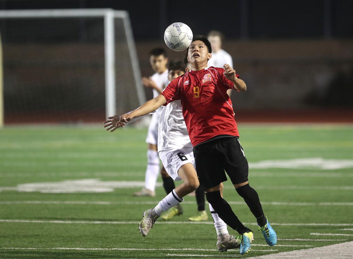 Ocean View's Gabriel Castellanos (9) takes control of a high kick during a boys' soccer match against Marina on Thursday.