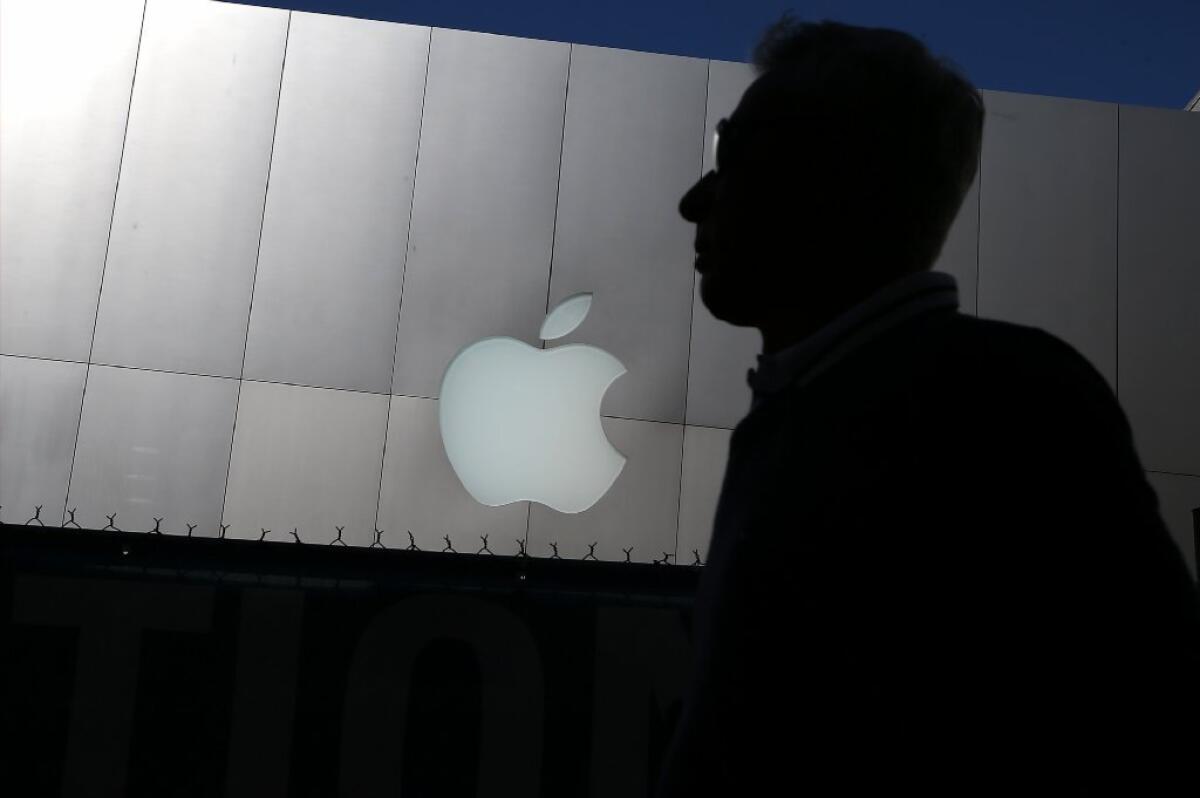 A person walks by an Apple store Tuesday in San Francisco.