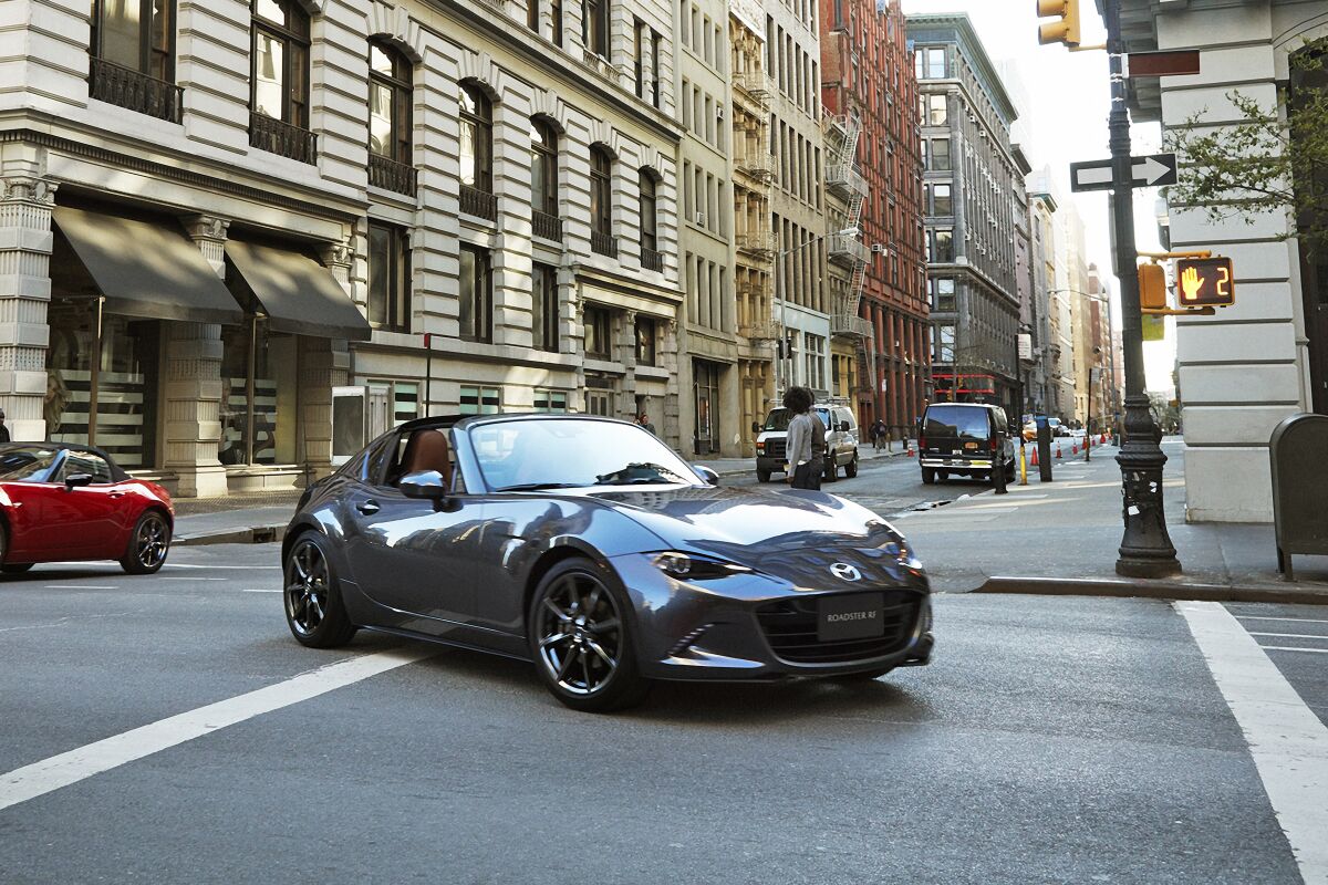 This photo provided by Mazda, shows the 2022 Mazda Miata MX-5 RF, a small rear-wheel-drive roadster with a retractable hardtop. (Courtesy of Mazda North American Operations via AP)
