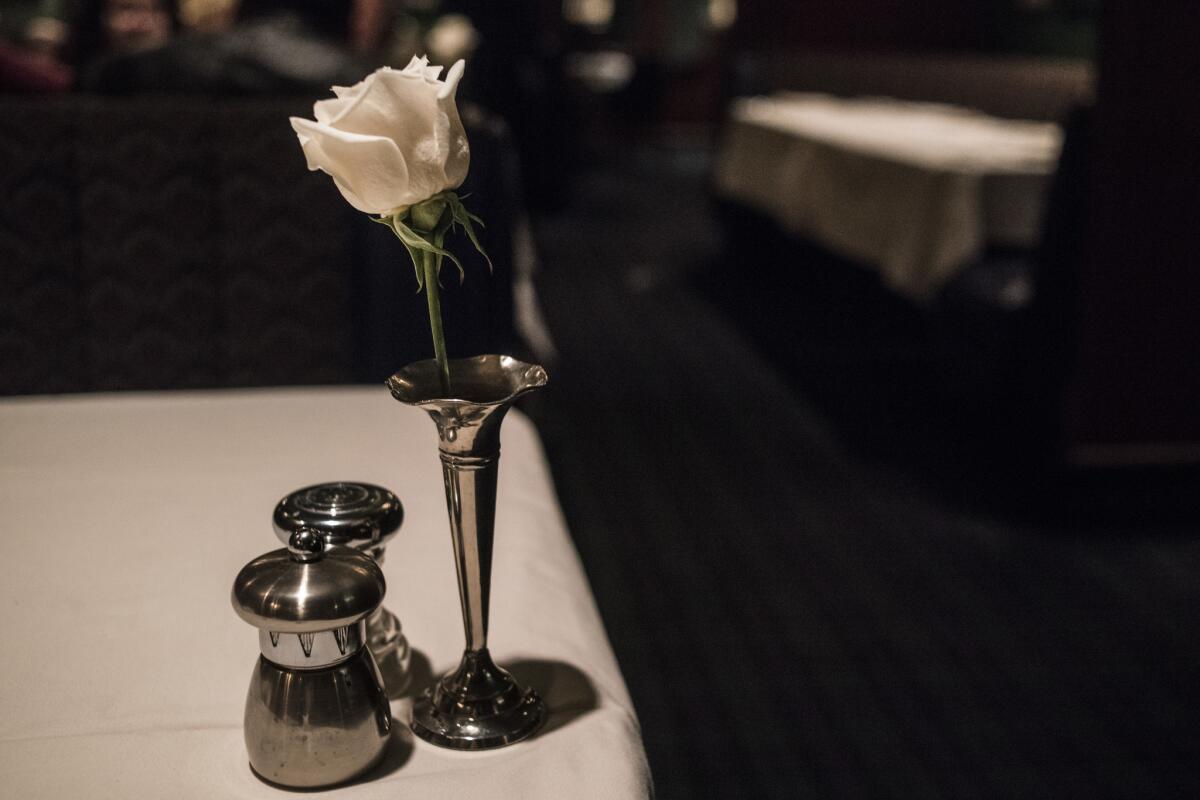 Each table at the Dining Car is set with a white rose.
