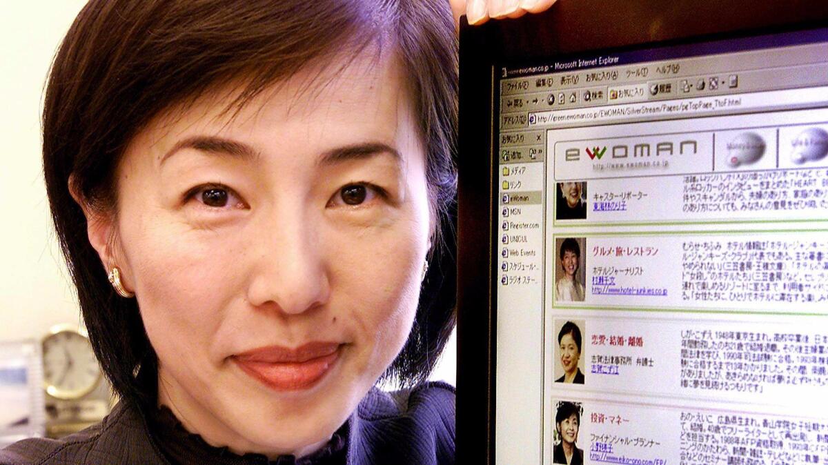 Japanese businesswoman Kaori Sasaki displays her company website at her office in Tokyo in 2000.
