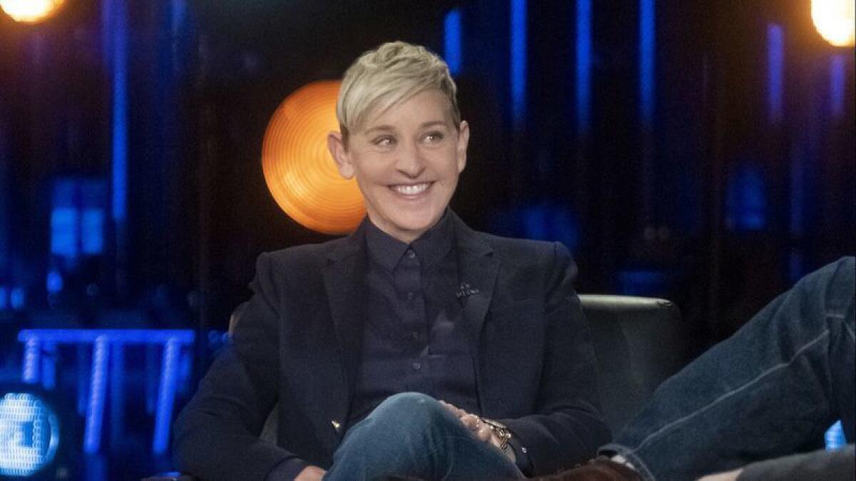Ellen DeGeneres sitting on a couch