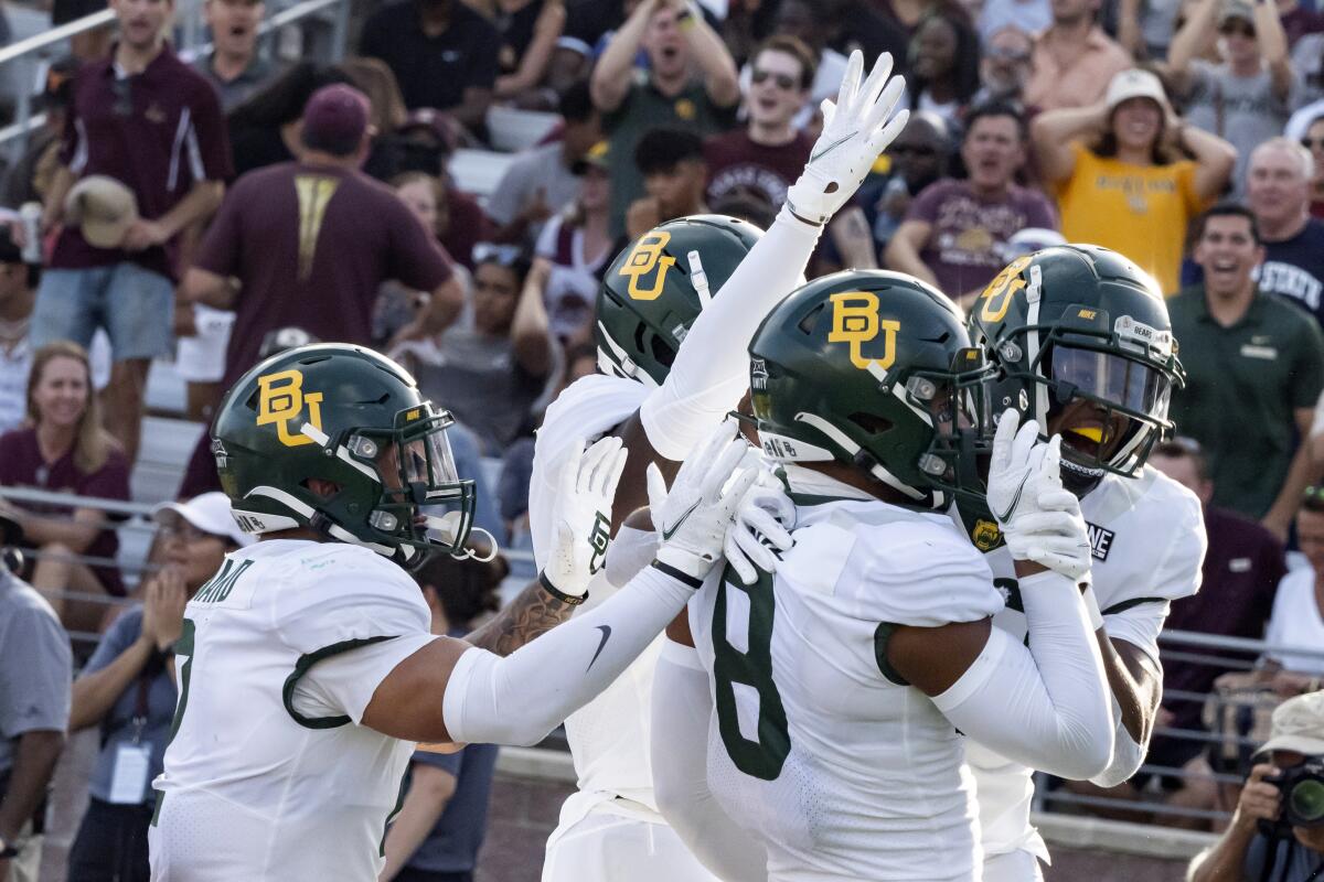 FILE - In this Saturday, Sept. 4, 2021, file photo, Baylor's JT Woods, right, celebrates with safety Jalen Pitre, center right, and other teammates after returning an interception for a touchdown during the first half of an NCAA college football game Texas State in San Marcos, Texas. Baylor’s defense had three interceptions in the season opener .AP Photo/Michael Thomas)
