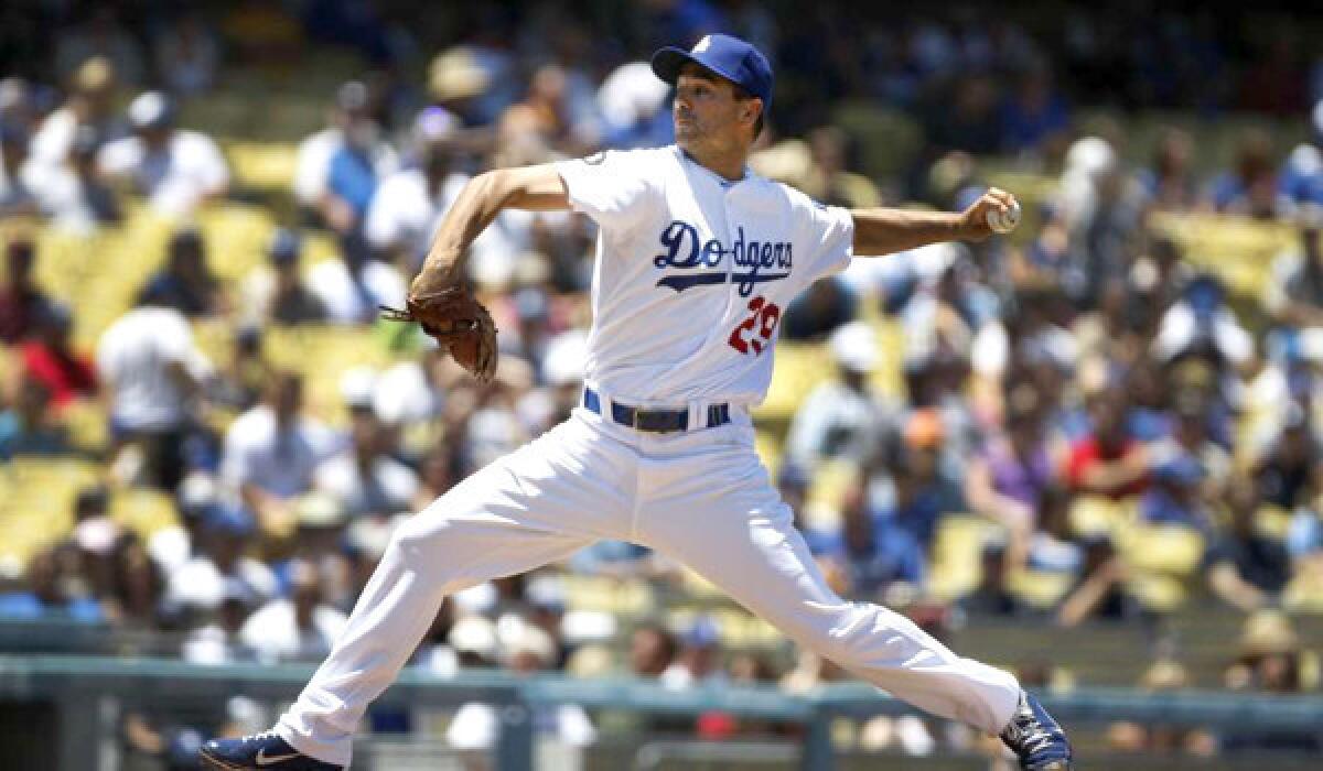 Dodgers pitcher Ted Lilly delivers a pitch against the Padres in the second inning at Dodger Stadium.
