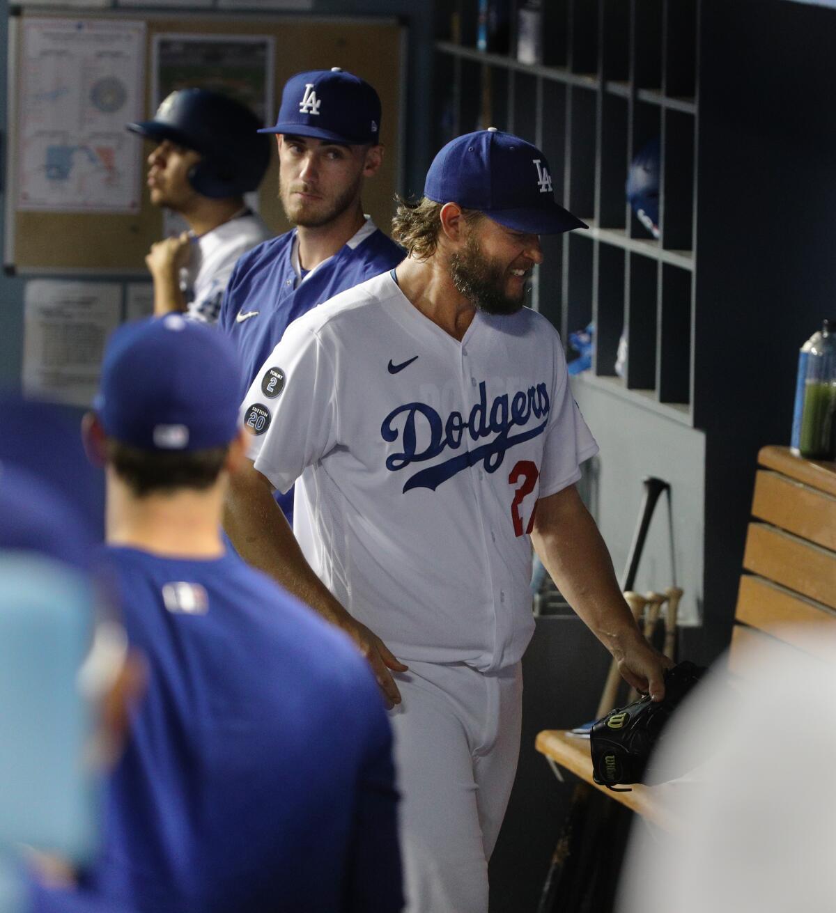 Dodgers starting pitcher Clayton Kershaw walks in the dugout after leaving Friday's game against the Milwaukee Brewers.