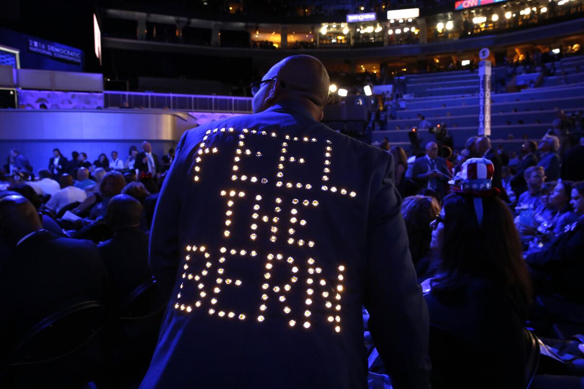 "Feel the Bern" lights up the back of a delegates jacket on the first night of the Democratic National Convention in Philadelphia.
